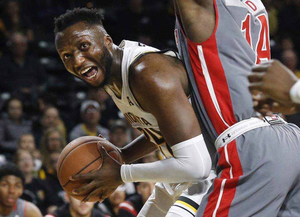 Wichita State’s Morris Udeze (24) looks for a path to the basket around Gardner-Webb’s Kareem Reid (14) in the first half of Tuesday’s game.