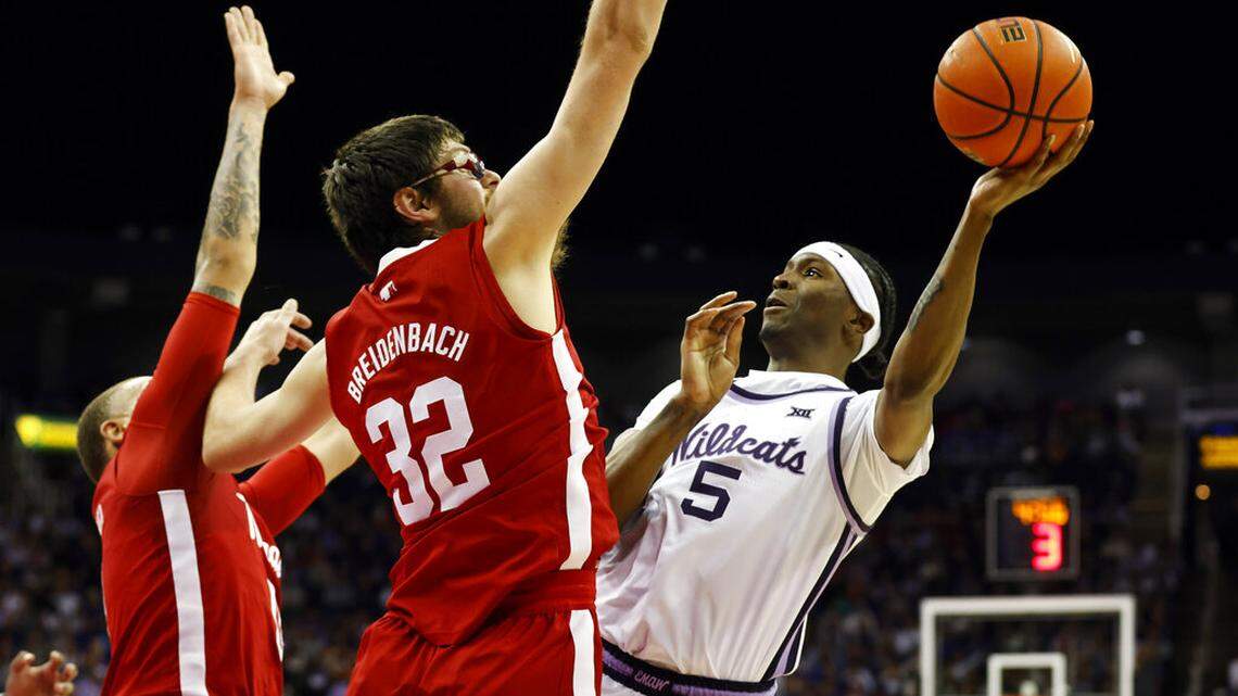 Kansas State guard Cam Carter (5) attempts to score against Nebraska forward Wilhelm Breidenbach (32) during the first half of an NCAA college basketball game in Kansas City, Mo., Saturday, Dec. 17, 2022. (AP Photo/Colin E. Braley)