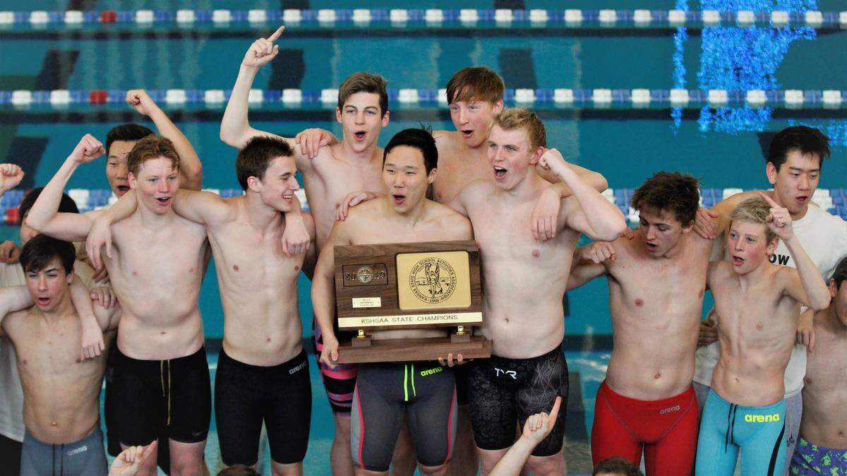 Blue Valley West hoists the Class 6A state championship trophy.