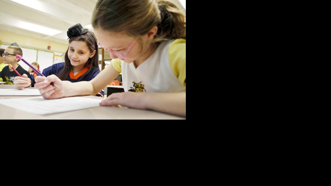 Cleaveland Traditional Magnet Elementary School fourth-graders Alexyha Raven, left, and Jordan Green work on a math problem during core study. (March 7, 2014) 

