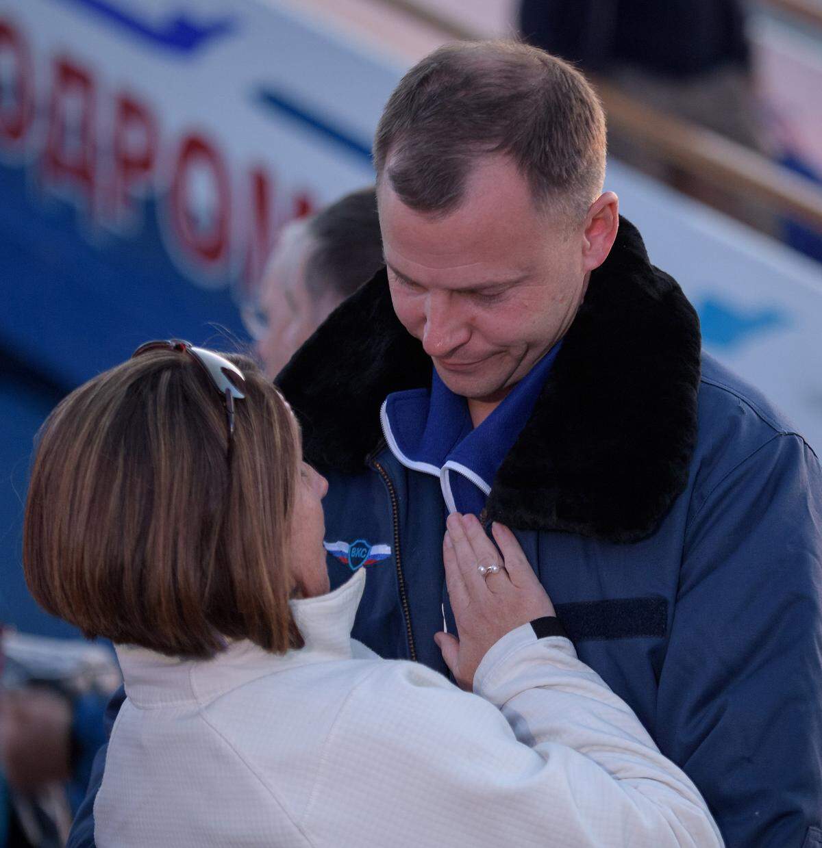 U.S. astronaut Nick Hague embraces his wife, Catie, after landing at the Krayniy Airport in Baikonur, Kazakhstan.