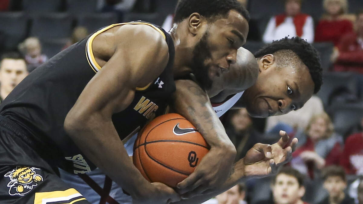 Wichita State forward Markis McDuffie fights for a rebound against Oklahoma forward Kristian Doolittle during the first half of their game at Chesapeake Energetic Arena in Oklahoma City on Saturday.