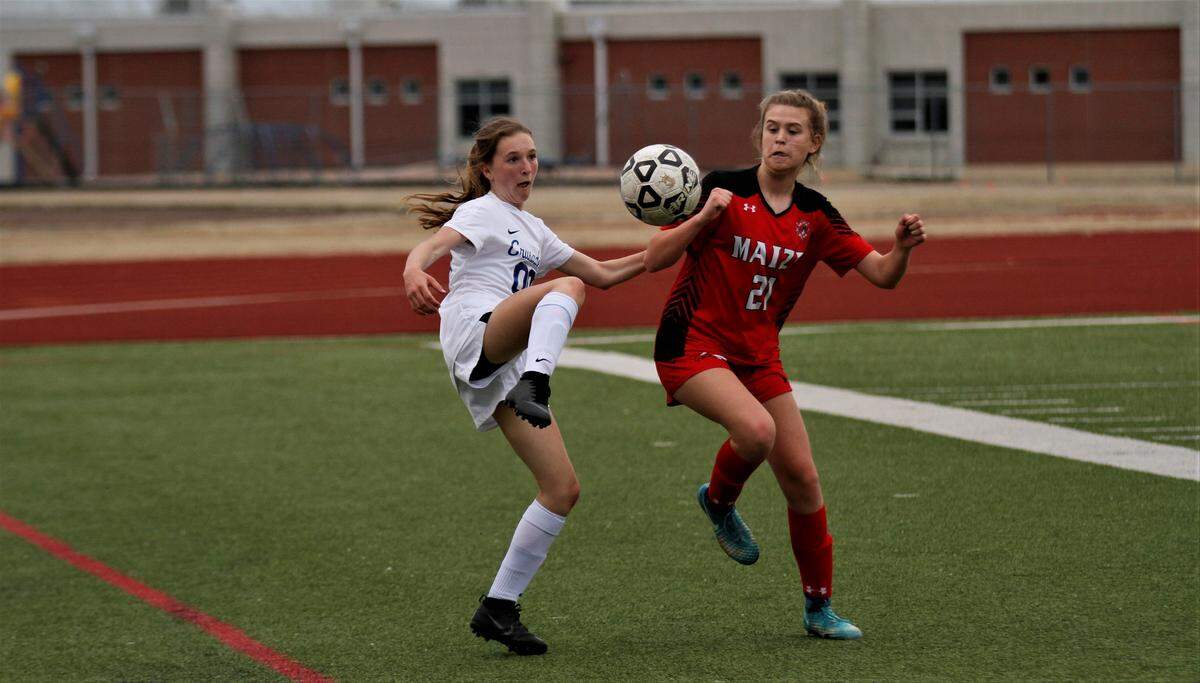 Kapaun’s MaKenzie Orr and Maize’s Taige Webster