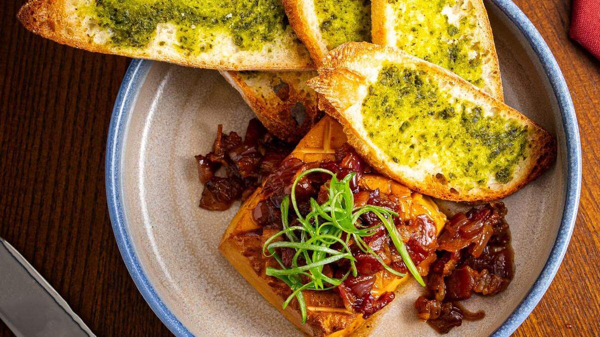 An example of the type of shareable small-plate dishes that will be availability at Doma: smoked cheese with bacon onion relish and grilled bread.
