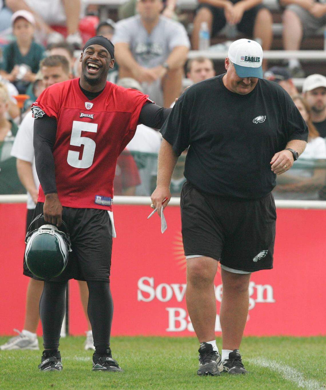 Aug. 15, 2006: Quarterback Donovan McNabb and head coach Andy Reid share a laugh on the sidelines during Philadelphia Eagles training camp in Bethlehem, Pennsylvania.