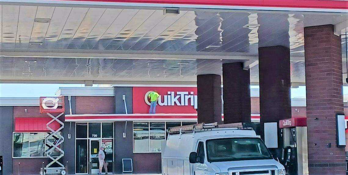 Workers being dismantling the QuikTrip brand from a store north of downtown Wichita. QuikTrip at Broadway and Murdock permanently closed Tuesday at noon.