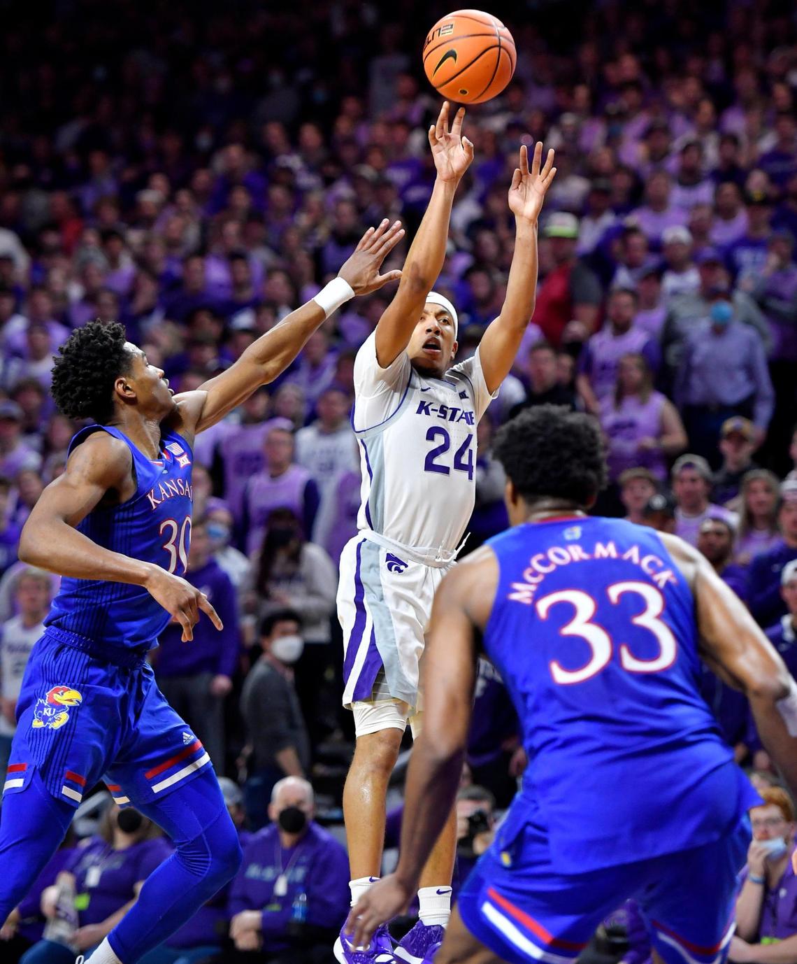 K-State’s Nijel Pack shoots over KU’s Ochai Agbaji and David McCormack during the first half of Saturday’s Big 12 Conference game at Bramlage Coliseum. Pack had 22 points in the opening half.