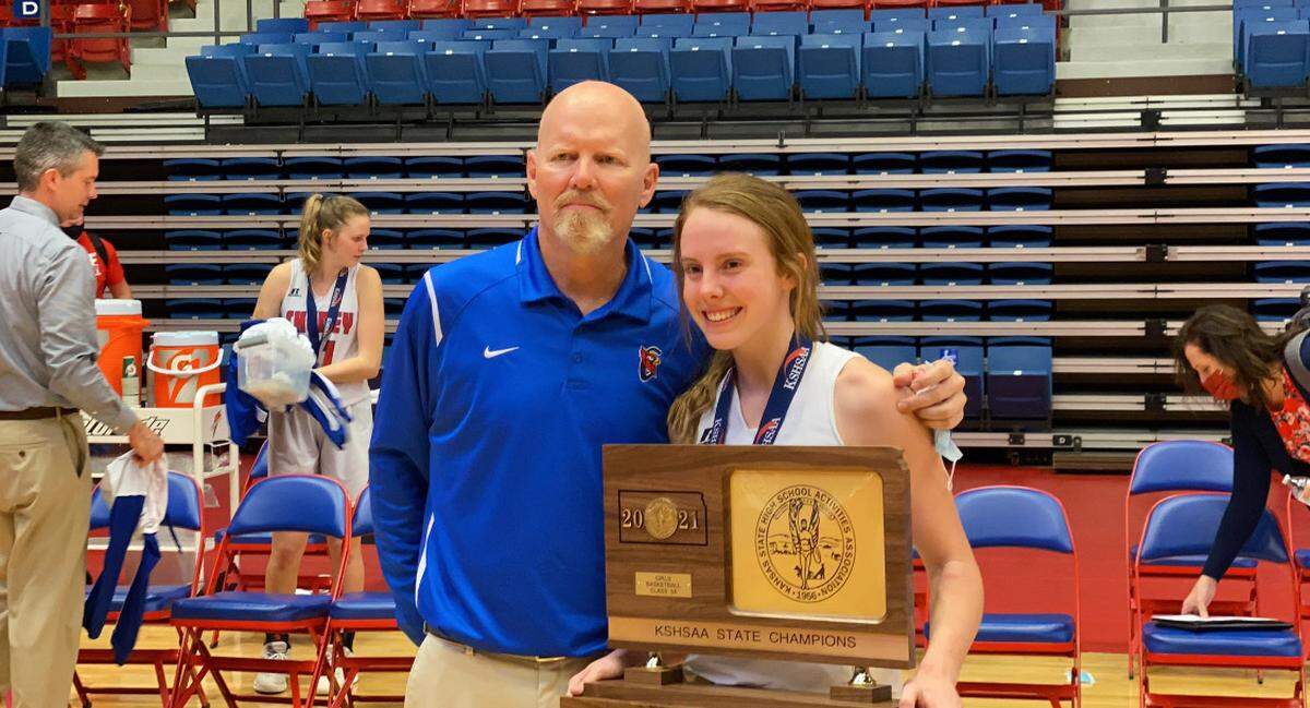 Cheney coach Rod Scheer and his daughter Kylee pose with the Class 3A championship trophy. Kylee was the star player for the Cardinals, as Rod won state titles with both of his daughters.