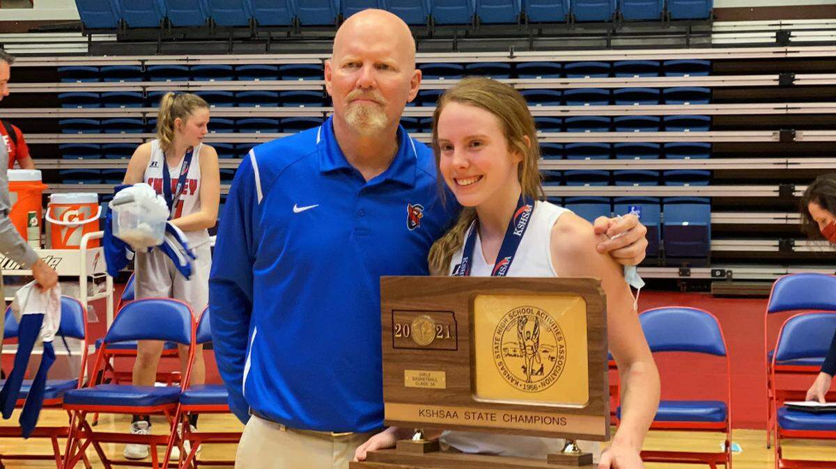 Cheney coach Rod Scheer and his daughter Kylee pose with the Class 3A championship trophy. Kylee was the star player for the Cardinals, as Rod won state titles with both of his daughters.