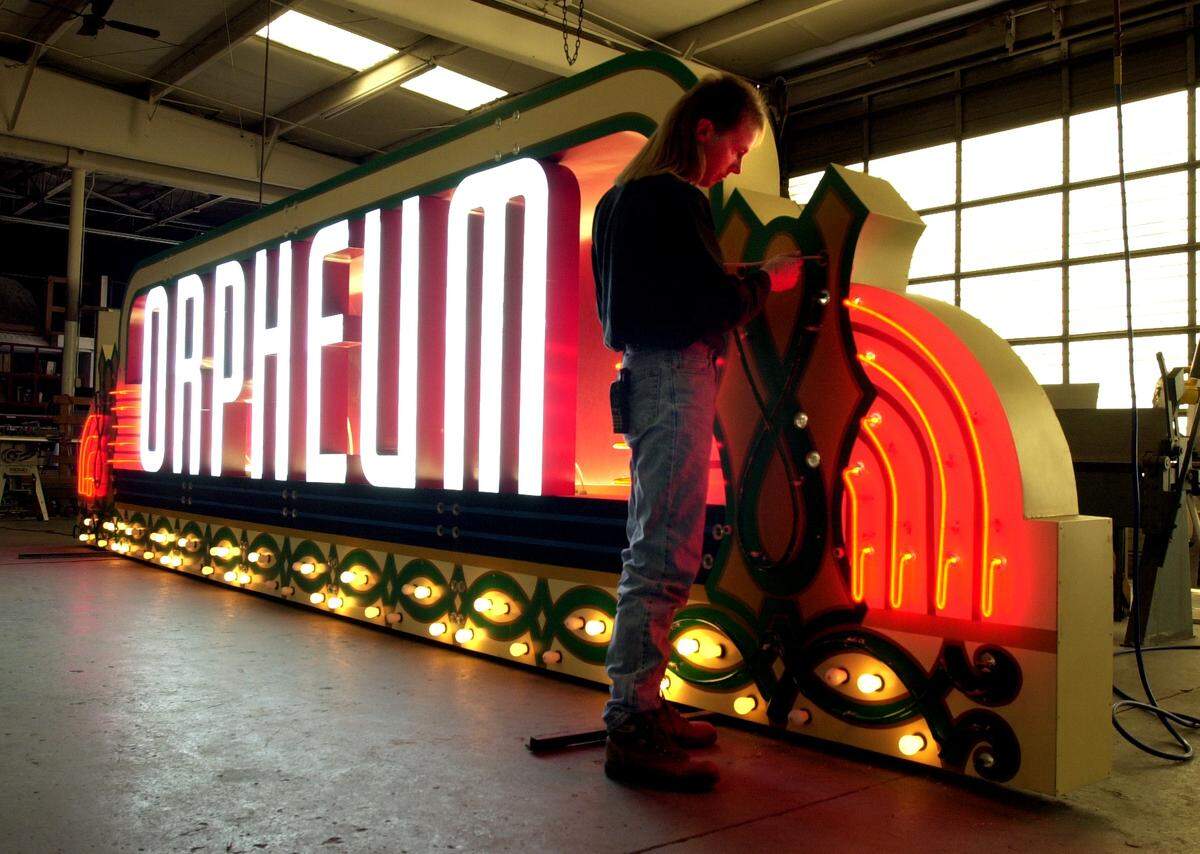 A worker is pictured in 2001 putting finishing touches on a new Orpheum Theater marquee before its installation.