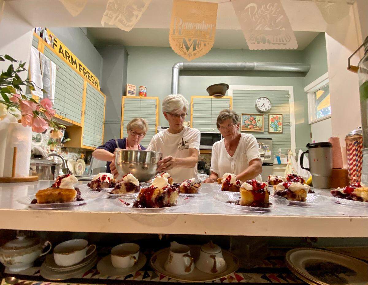 The “Soil Sisters” prepare blackberry cobbler for dessert at the Bartlett Arboretum.