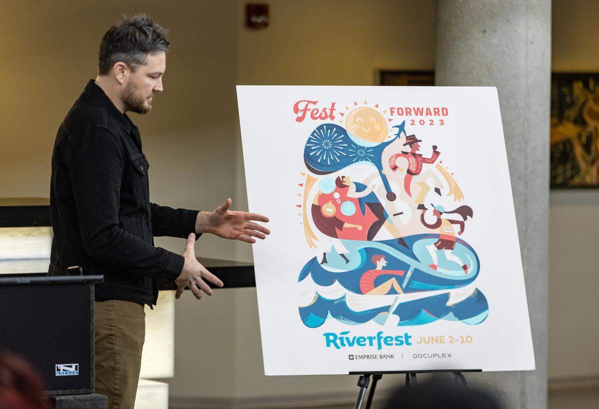 Adam Anderson talks about his design for this year’s River Festival logo during an unveiling at Emprise Bank on Monday. This year will mark the 51st year of the Wichita River Festival.