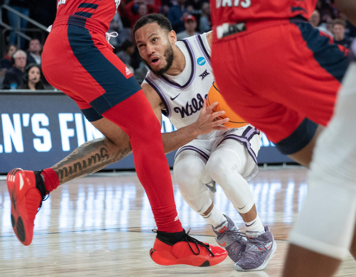 Kansas State’s Markquis Nowell runs into a wall of Florida Atlantic defenders during the second half of their east region final game at Madison Square Garden on Saturday night.