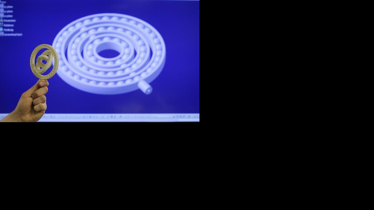 This ball bearing gear part started as a 3-D image on the screen. A 3-D printer, using melted hard plastic, then turned the image into an object. The object came out of the 3-D printer so exactly replicated that the separate circular gears all move smoothly within each other.

