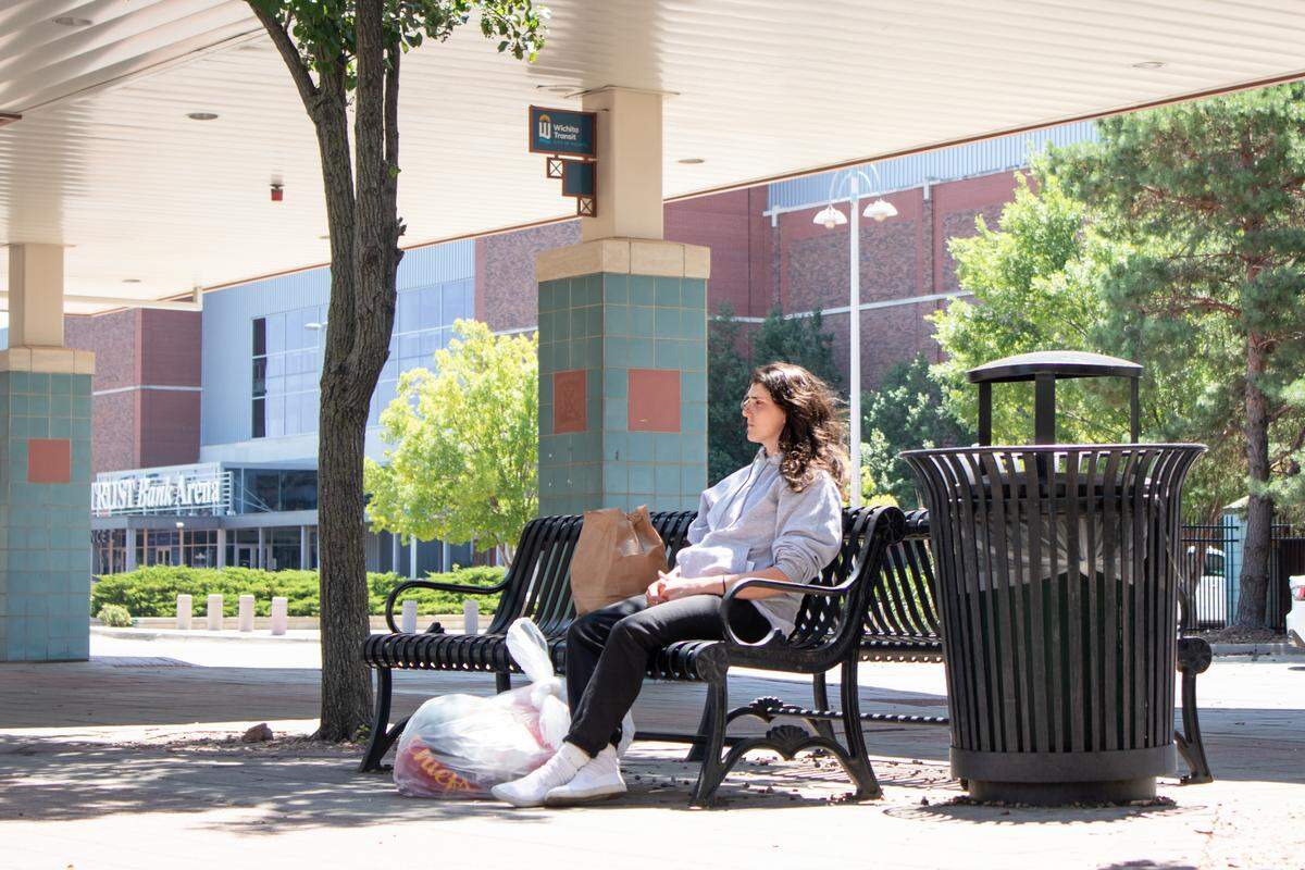 Emily Cleaver waits for her bus home after spending a year in Topeka’s correctional facility. Cleaver used to get around town by car, but after going to prison and losing her car, she anticipates riding the bus a lot more.