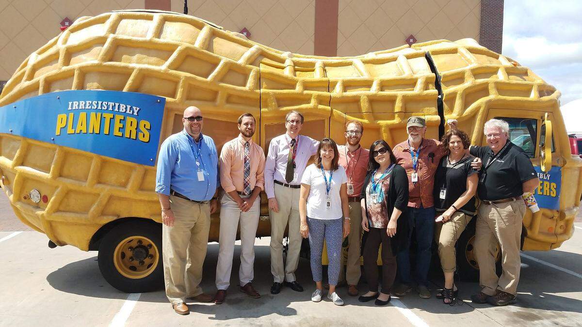 Tom Shine, third from left, hanging out with Wichita Eagle newsroom staffers and the visiting Planters NUTmobile. Staffers include, from left, late business reporter Jerry Siebenmark, sports reporter Taylor Eldridge, former school reporter Suzanne Perez, former features writer Matt Riedl, audience growth producer Julie Mah, former automotive writer Mike Berry, dining columnist Denise Neil and former photographer Bo Rader.