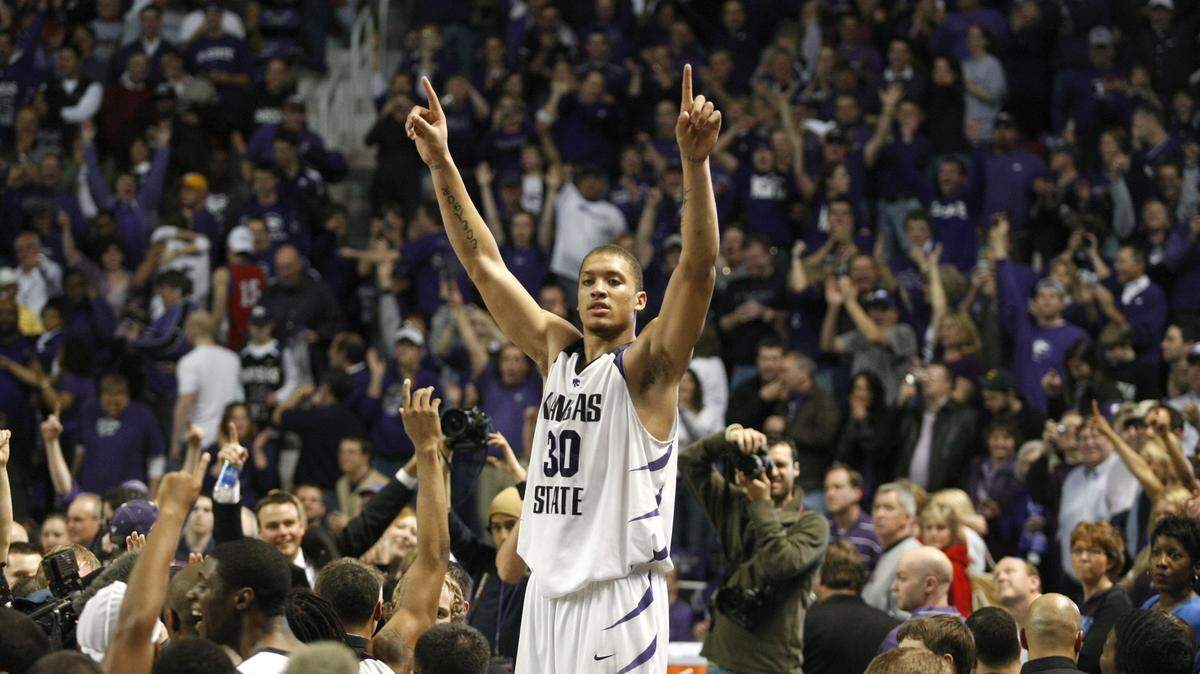 Kansas State's Michael Beasley celebrates with the crowd after the Wildcats beat KU in Manhattan for the first time in 25
years.