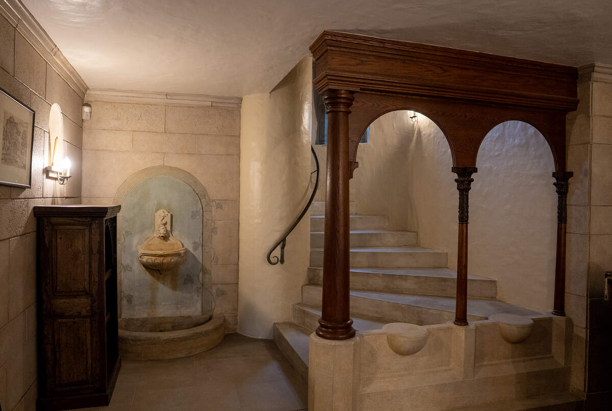 A winding stone staircase is visible just through the entry of The Clapp Manor at 320 N. Belmont.