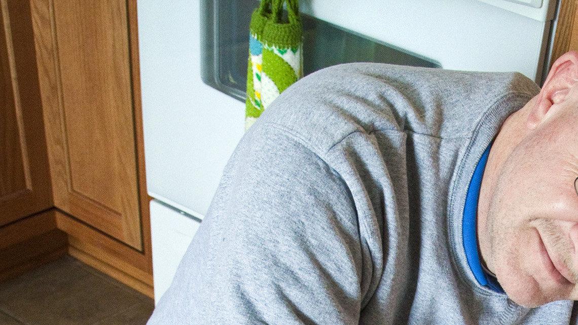 Maple Shade resident Steve Garner shows how the linoleum in his kitchen is stretching from a crack in the concrete that runs from the street, through his driveway, through the house and out to the end of his patio. (Dec. 22, 2010)