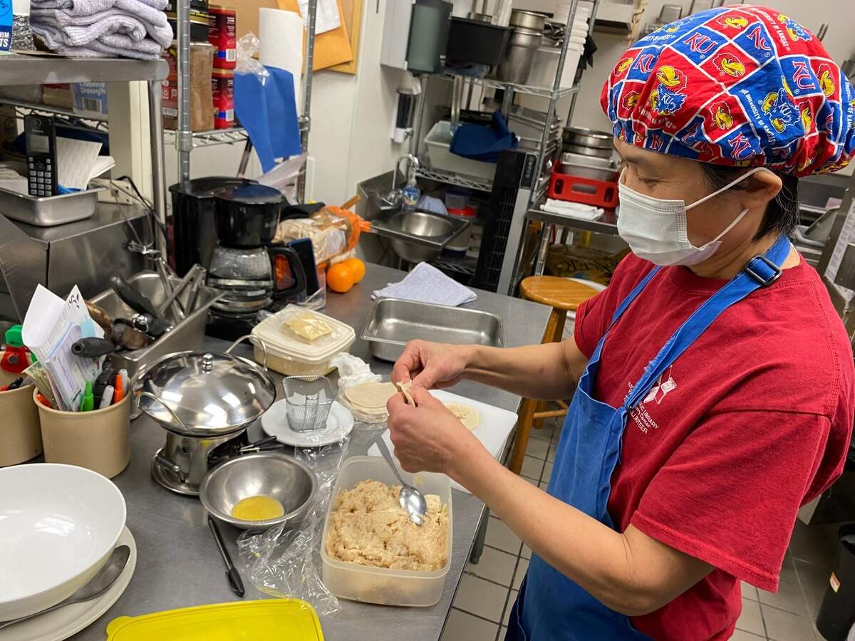 Yook Gan prepares homemade chicken dumplings in the kitchen of her new restaurant, Asian Wok, which is now open at 2929 N. Rock Road.