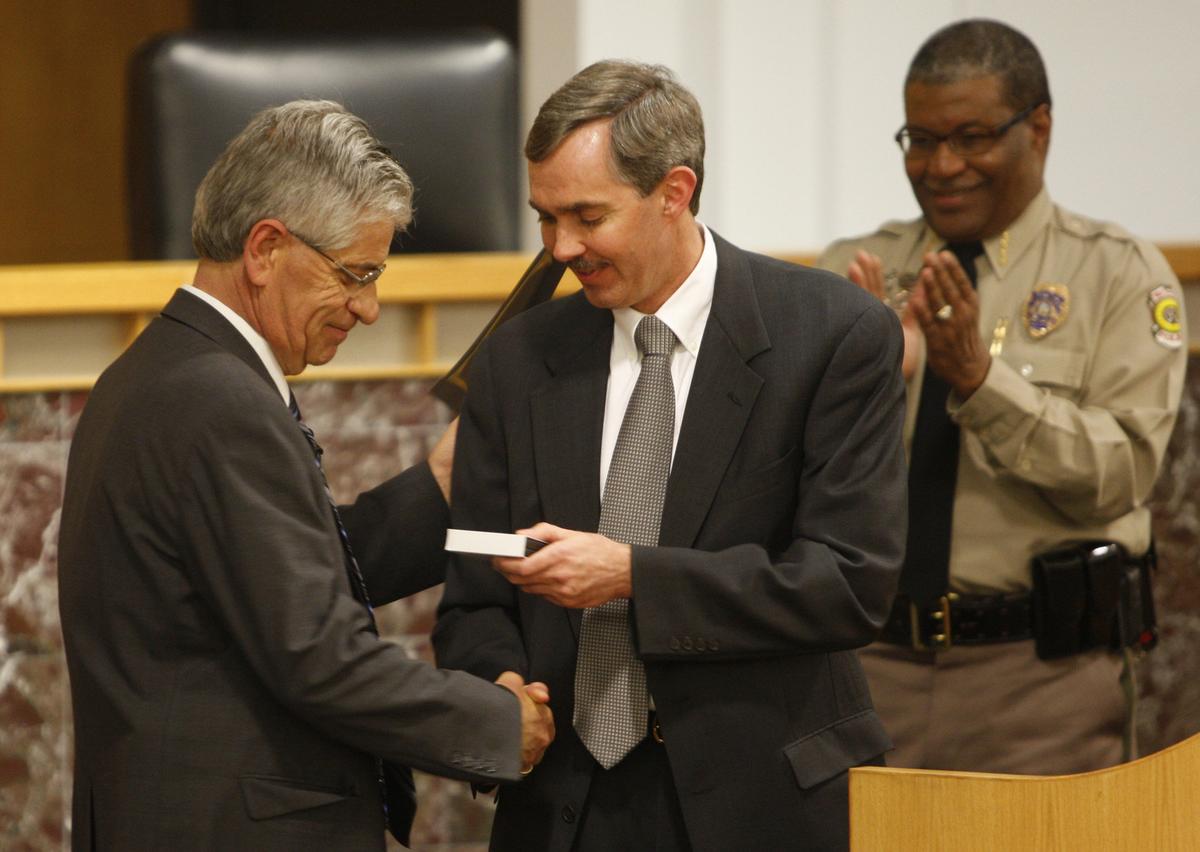 Wichita City Manager Robert Layton presents Lt. Ken Landwehr with a gift during his retirement ceremony in 2012. Landwehr was the Wichita police commander who helped solve the BTK serial-killer case.