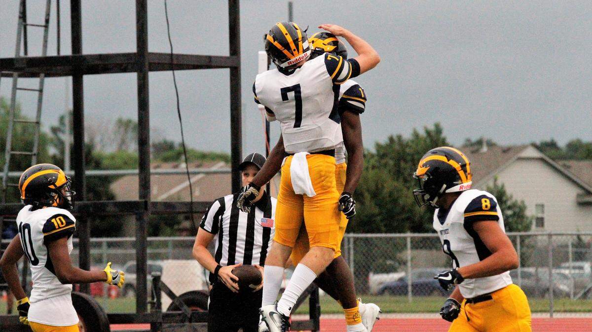 Wichita Northwest junior quarterback Reagan Jones celebrates with senior running back Breece Hall after a touchdown in the Grizzlies’ 56-0 win over the Blue Aces on Thursday night. (Sept. 6, 2018)