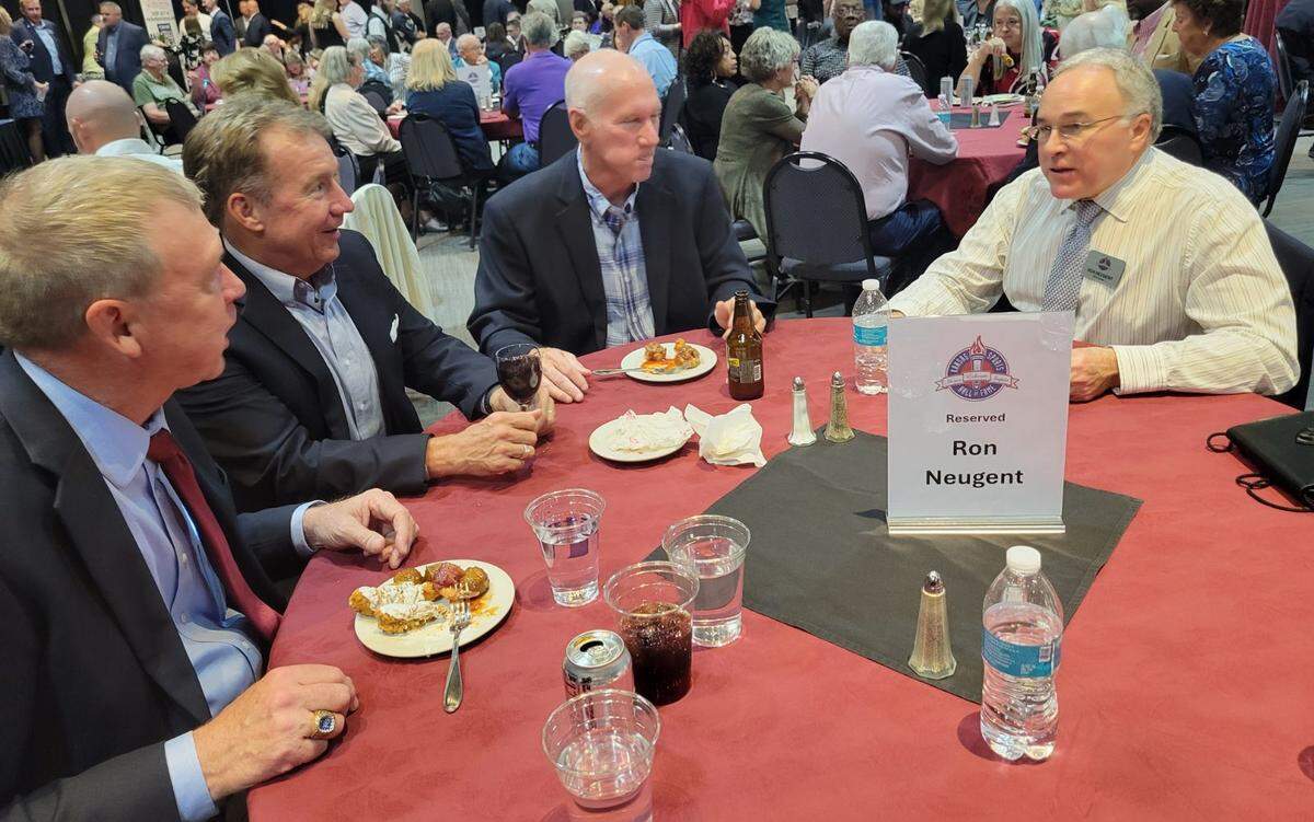 Wichita native Ron Neugent (far right) talks with former swimming teammates from Wichita Swim Club and the University of Kansas during his induction ceremony into the Kansas Sports Hall of Fame earlier this month.
