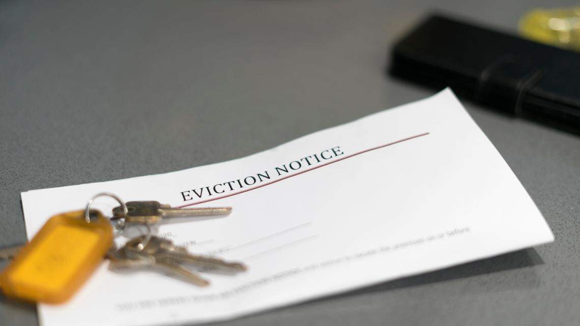 House keys sitting on an eviction notice received in the mail.