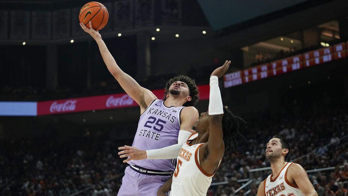 Kansas State forward Ismael Massoud (25) shoots over Texas guard Marcus Carr (5) during the first half of an NCAA college basketball game in Austin, Texas, Tuesday, Jan. 3, 2023. (AP Photo/Eric Gay)