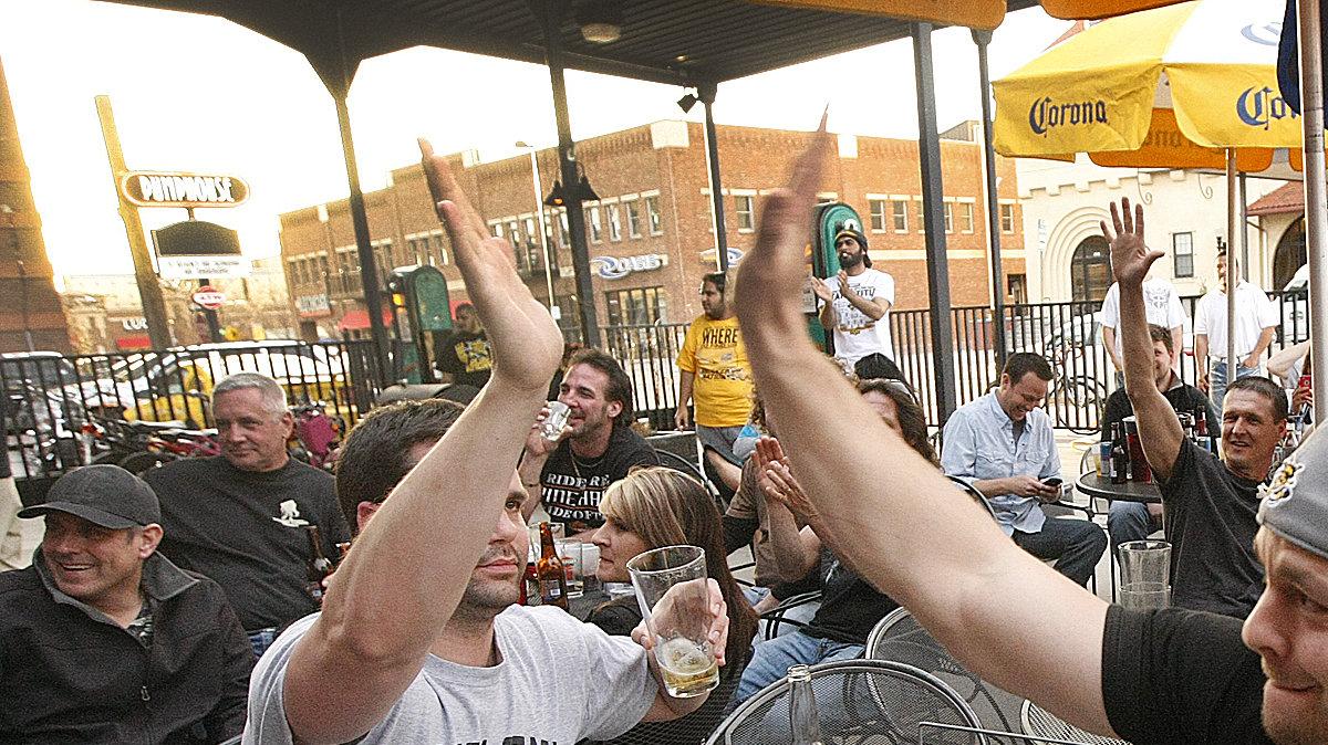 WSU fan Jarrod Nolan, right, watching the game at the Pumphouse cheers on the Shockers during the NCAA semifinal Saturday. (April 6, 2013)