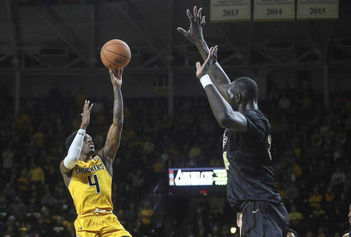 Wichita State guard Samajae Haynes-Jones shoots over 7-6 UCF center Tacko Fall during the second half of their game at Koch Arena on Wednesday.