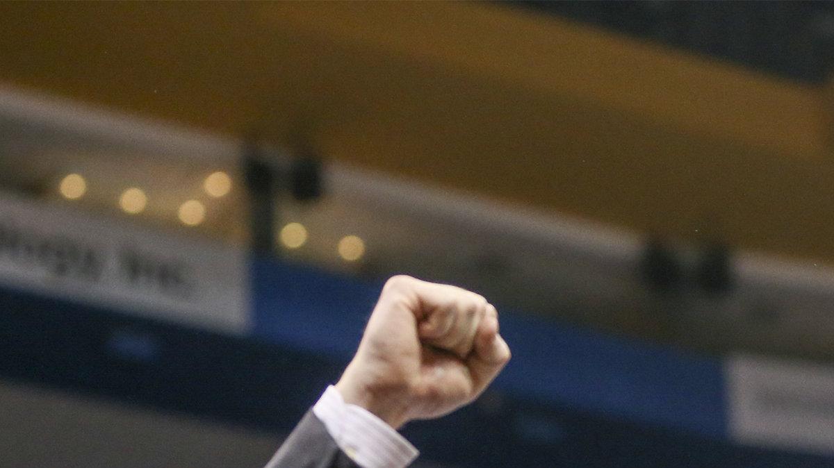 Wichita State coach Gregg Marshall raises his fist as his team holds up the championship trophy after winning the Missouri Valley Conference Tournament in St. Louis Sunday.  (March 9, 2014)