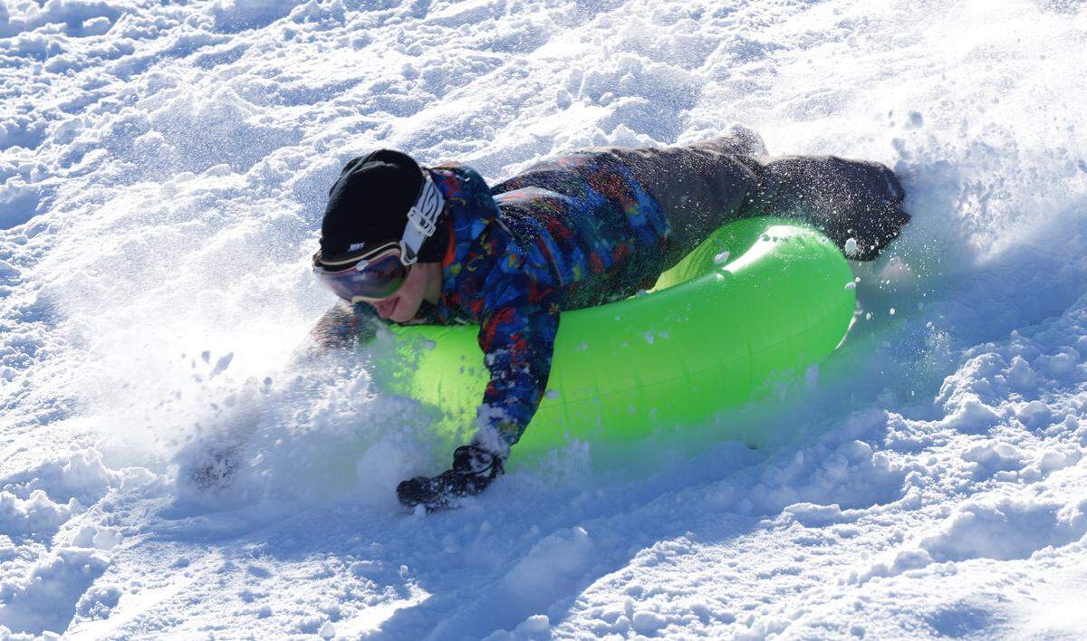 A sledder slides down a hill at Linear Park in Goddard. About six inches of snow fell in the Wichita area late Thursday evening. 