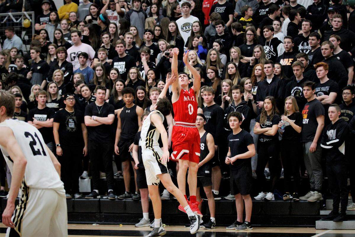Maize senior Caleb Grill fires a three-pointer in front of the Maize South student section during the Eagles’ 65-63 win over their rival Friday night. (Feb. 1, 2019)