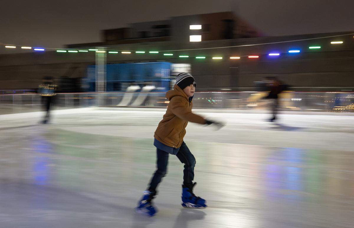 A skater glides across the ice rink set up as part of Somewhere in Winter, a downtown holiday event that will run through Jan. 4.