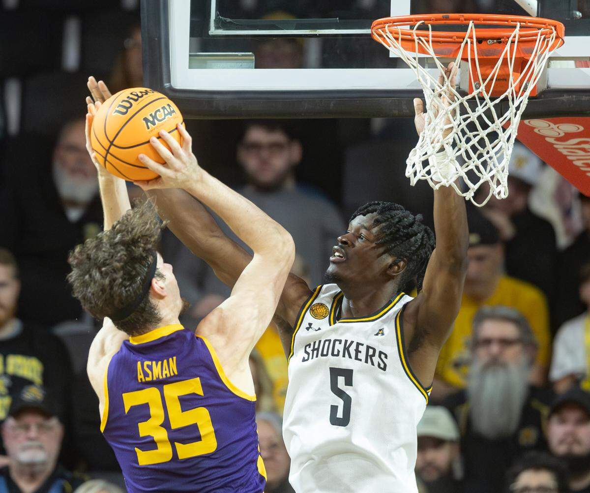 Wichita State’s Isaac Abidde defends Lipscomb’s Grant Asman during the first half of their season opener on Monday night at Koch Arena.