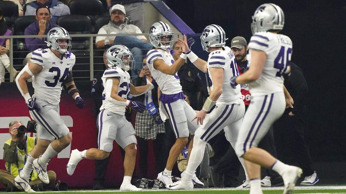 Kansas State wide receiver RJ Garcia II, center, celebrates his touchdown with teammates in the second half of the Big 12 Conference championship NCAA college football game against TCU, Saturday, Dec. 3, 2022, in Arlington, Texas. (AP Photo/LM Otero)