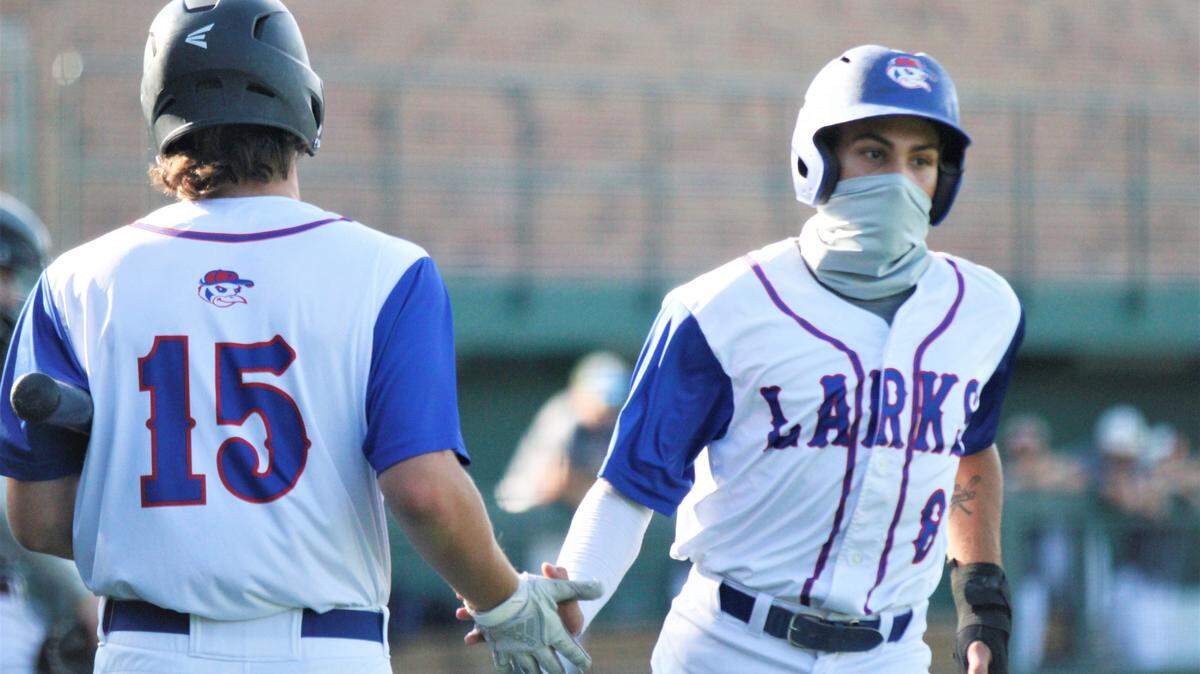 Max McGuire (left) and Leo Jiminian (right) of the Hays Larks high-five during the 86th annual NBC World Series in Wichita.