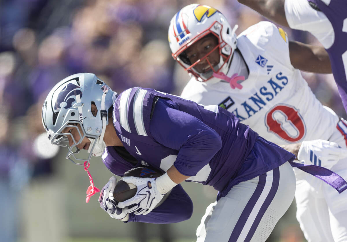 Kansas State safety Logan Bartley intercepts a Kansas pass in the end zone during the second half of their game in Manhattan on Saturday.