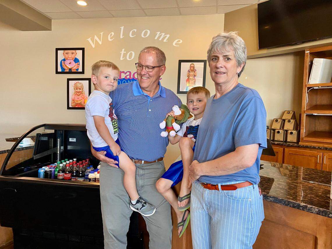 Paradise Donut owners Hervey and Marilyn Wright are ready to retire and spend more time with their grandsons Hudson, left, and Cooper, second from right.