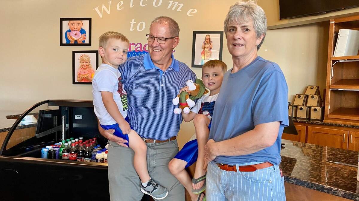 Paradise Donut owners Hervey and Marilyn Wright are ready to retire and spend more time with their grandsons Hudson, left, and Cooper, second from right.
