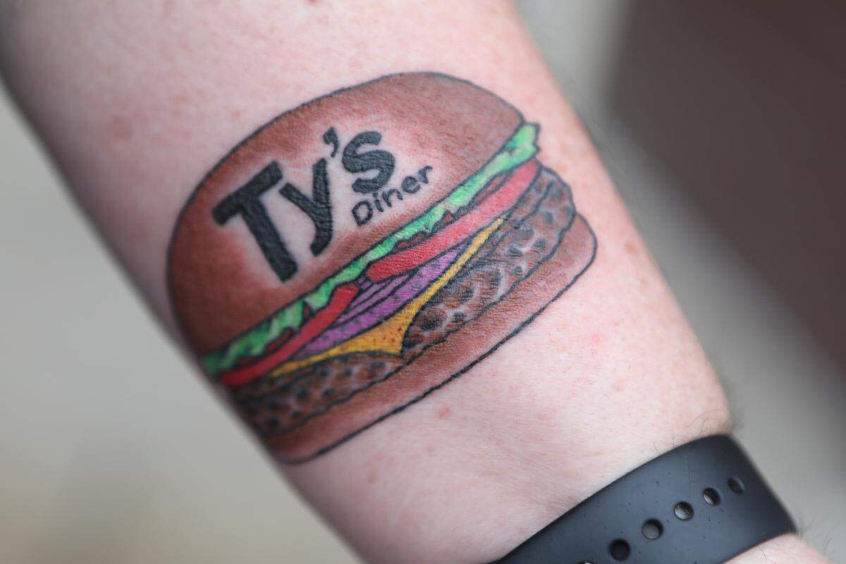 Mark Klamm. A 58-year-old process engineer group leader at Textron, had the Ty’s Diner logo tattooed on his left arm in exchange for free burgers for life. (March 29, 2019)