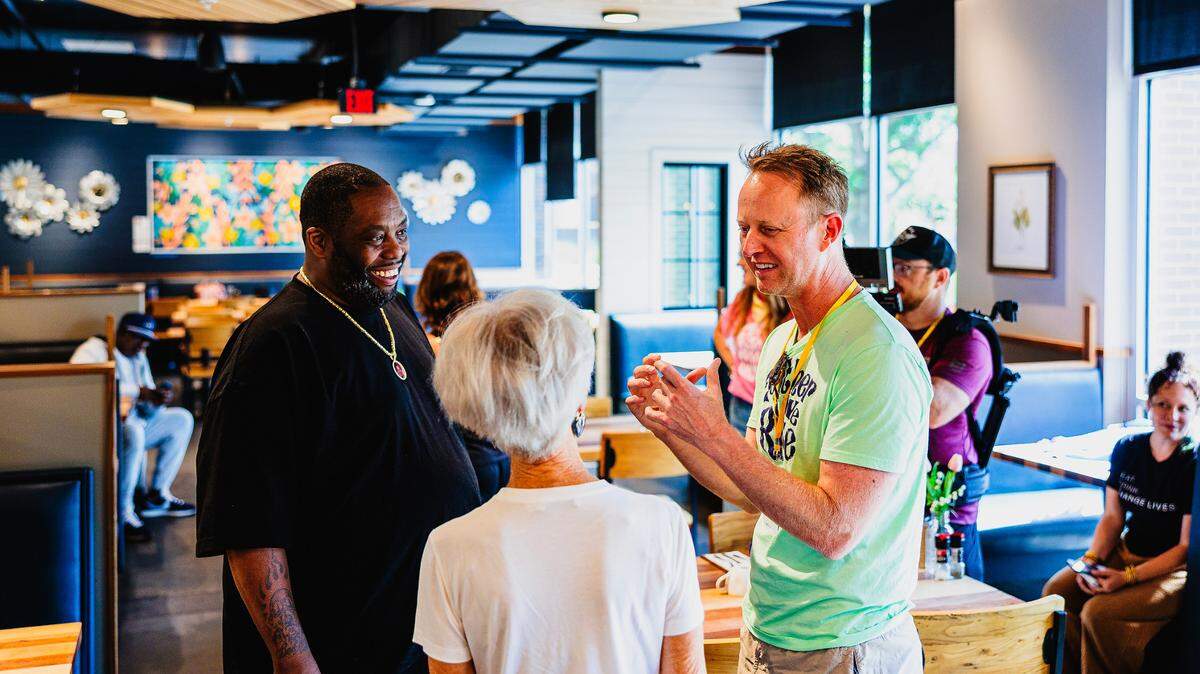Chase Koch, right, speaks with his mother, Liz, and rapper and free speech advocate Killer Mike at last year’s Elsewhere Fest & Conference, which has been renamed Somewhere Fest & Conference for this year’s June 13 and 14 event. Koch’s Movement Musick has plans for much more than a festival only.