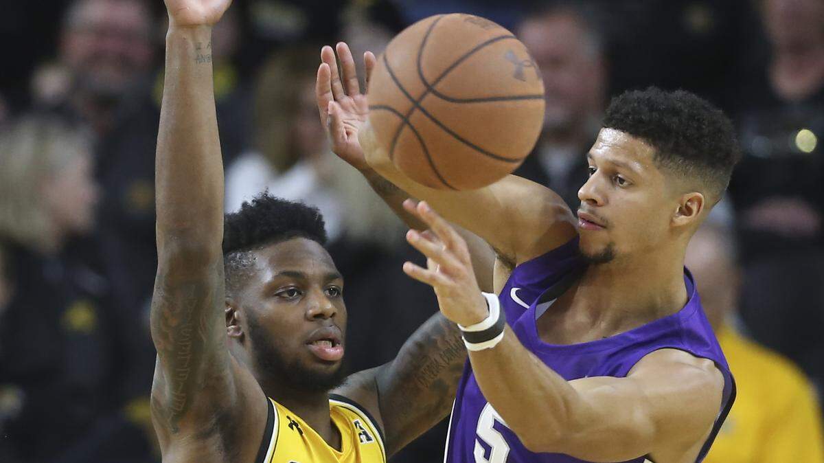 Wichita State’s Jamarius Burton defends Abilene Christian’s Payten Ricks while scrambling for a loose ball during the first half of their game at Koch Arena on Sunday.