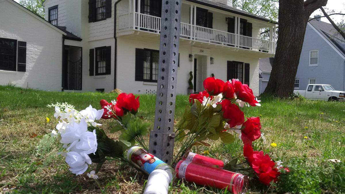 An impromptu memorial of flowers and candles sits outside of 254 N. Battin, where a homicide occurred early Sunday morning.