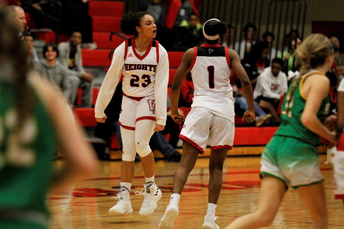 Wichita Heights’ Zyanna Walker (left) and Laniah Randle (right) celebrate a 45-35 win over Bishop Carroll on Tuesday night. (Jan. 9, 2019)