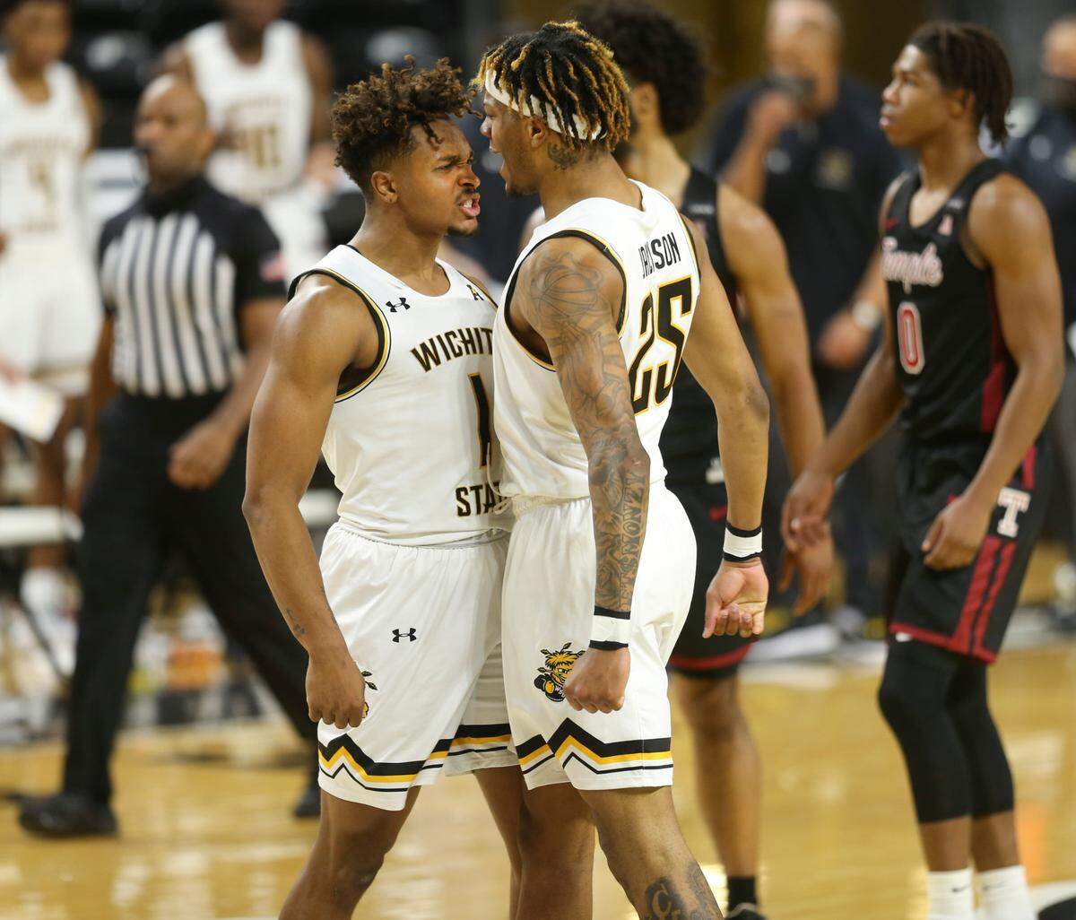 Wichita State University’s Tyson Etienne, left, cheers for Clarence Jackson after Jackson took a charging foul in the final minutes against Temple University at Koch Arena on February 7, 2021.