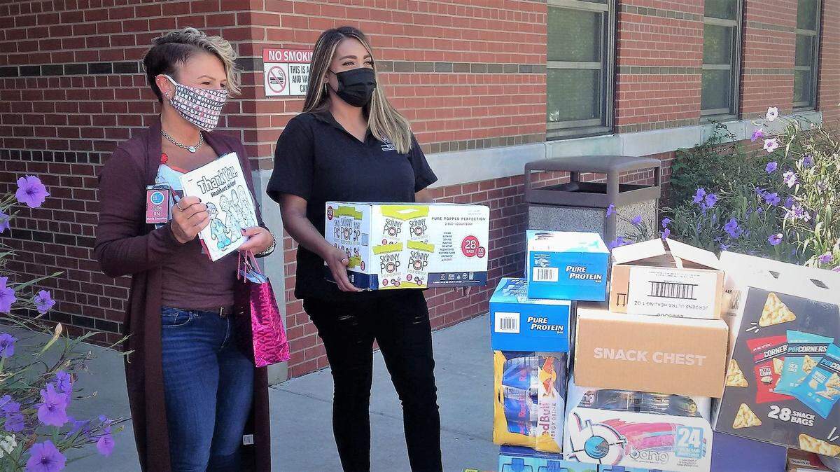 Sedgwick County Commissioner Sarah Lopez (right) delivers cartons of snacks and energy drinks to Julie Cotton, nurse executive at the Bob Dole Veterans Administration Medical Center. Lopez gathered the supplies through a community donation drive to thank Wichita medical workers for their service during the COVID pandemic.