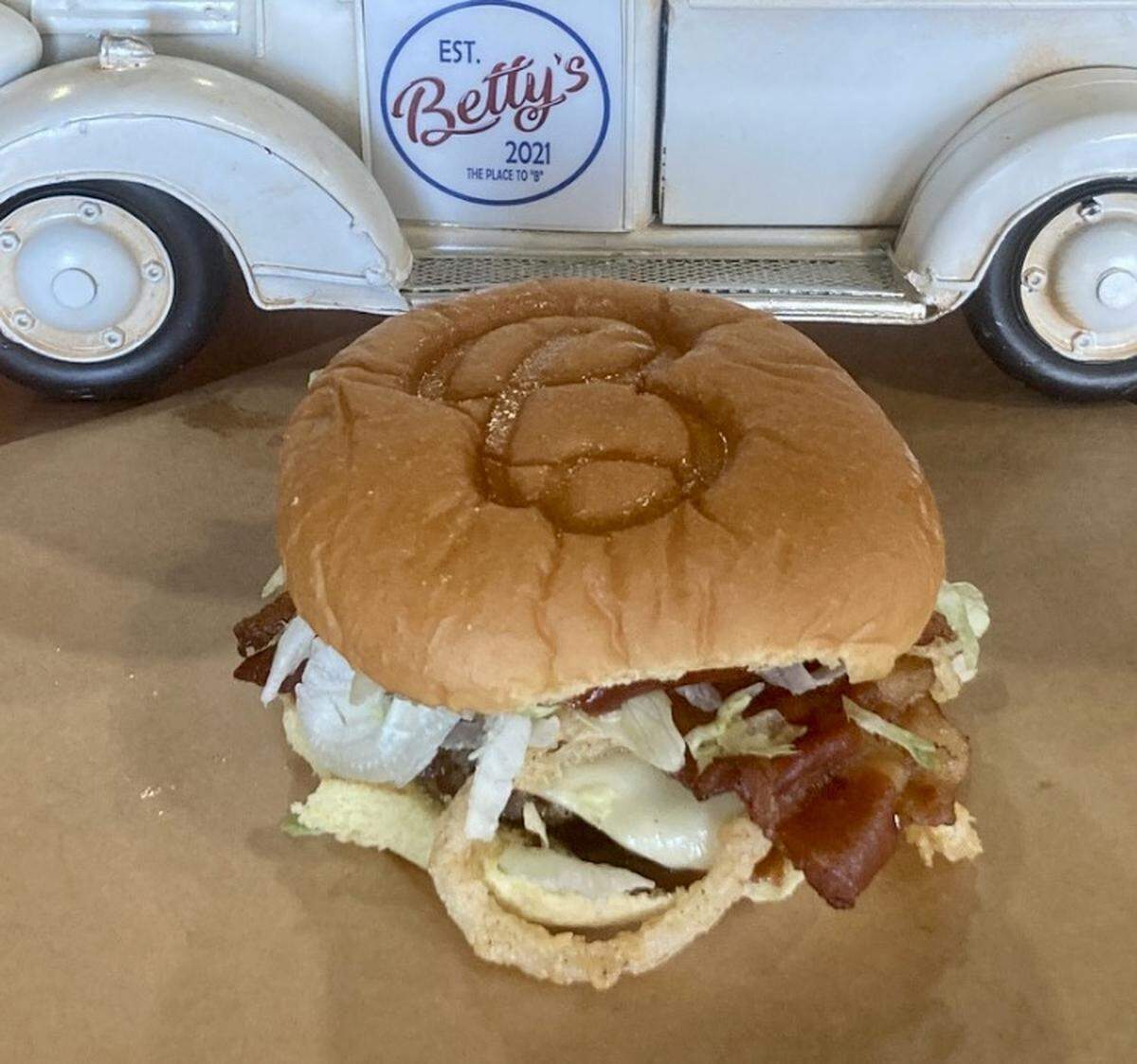 The Black Knight, topped with homemade onion strings and barbecue sauce, is Betty’s signature burger.