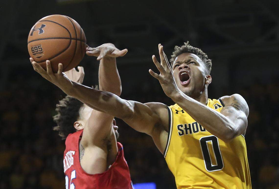 Wichita State guard Dexter Dennis goes to the basket against Southern Methodist forward Ethan Chargois during the second half of their game at Koch Arena on Wednesday. 